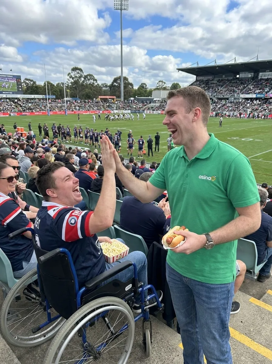 Ben Feenan sharing a high-five with a participant at the footy
