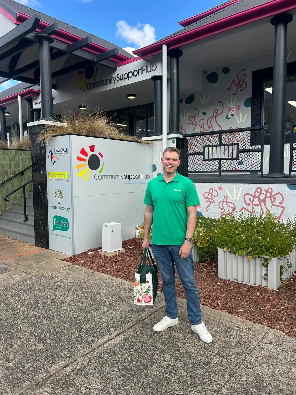 Ben Feenan outside the Community Support Hub in his Asina polo